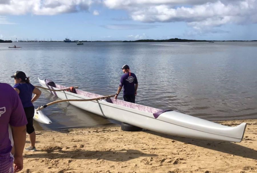 As the first races kick off, Kumulokahi paddlers for the 2019-20 Na Opio paddling championships prepare their canoes at Ke’ehi Lagoon.  