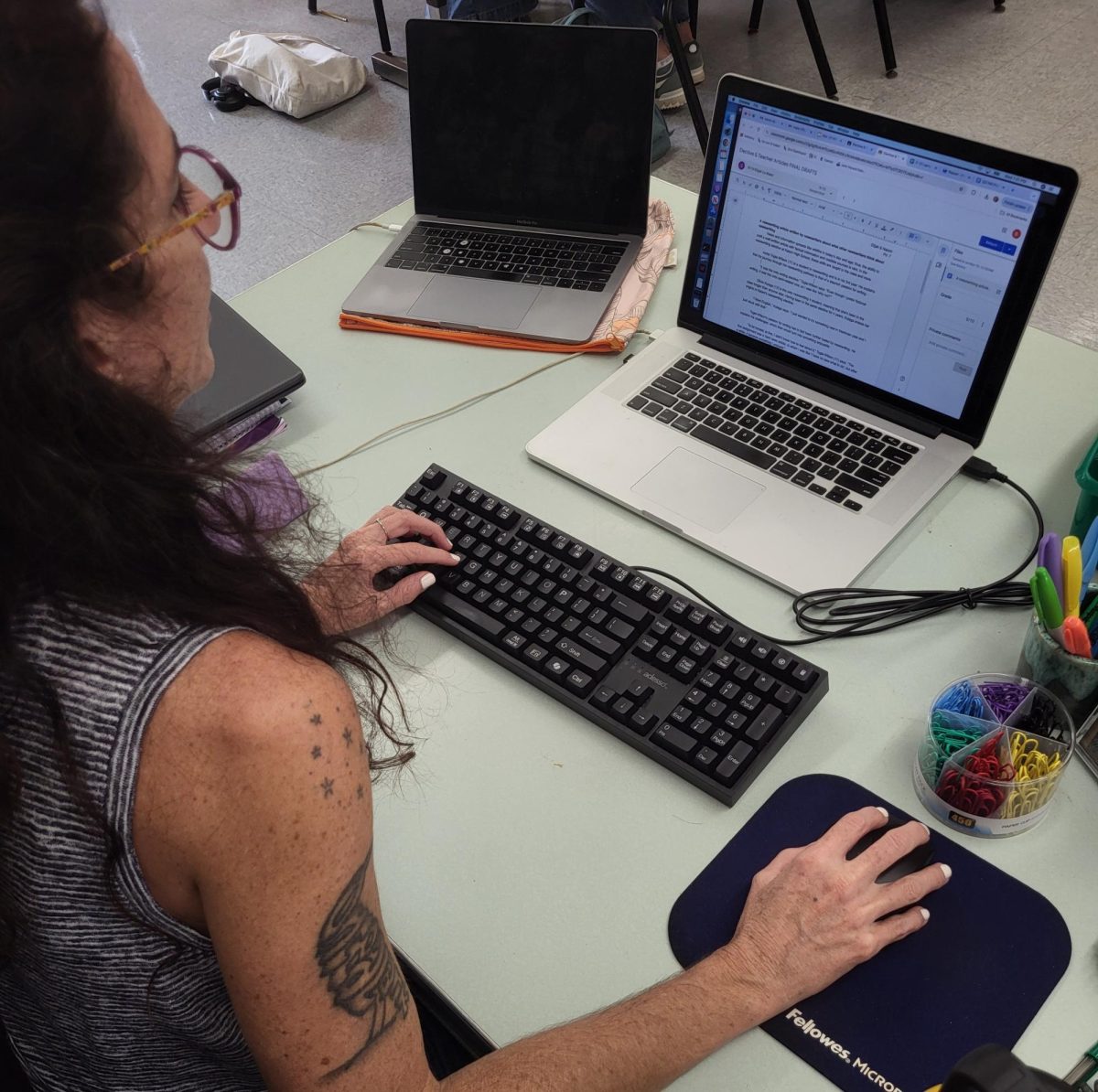 News writing teacher Ms. Nasser edits a student article during class. 