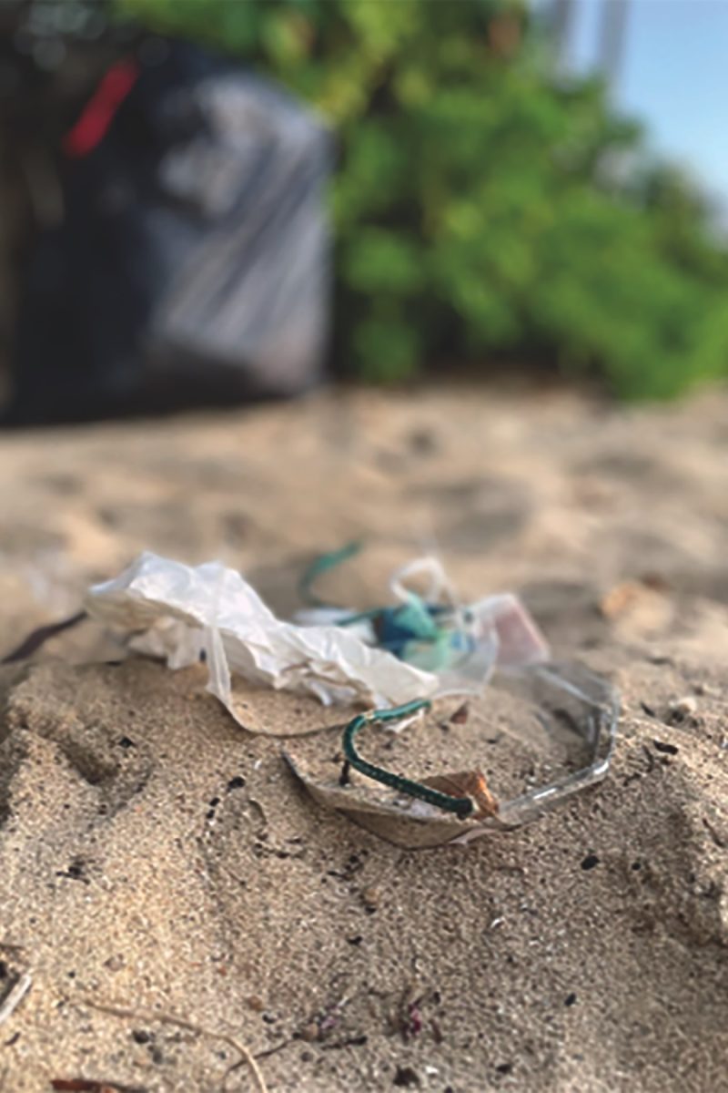 Bits of plastic lie tangled together and half-buried in the white sandy beach at Kaimana in Kailua. Plastics post a significant environmental challenge in Hawai'i, a state renowned for its stunning natural landscapes and rich biodiversity. The islands are particularly vulnerable to the impacts of plastics pollution, as ocean currents transport debris from distance shores. 